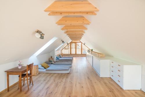 a living room with a couch and a wooden ceiling at Hiša sonca Toti breg in Svečina