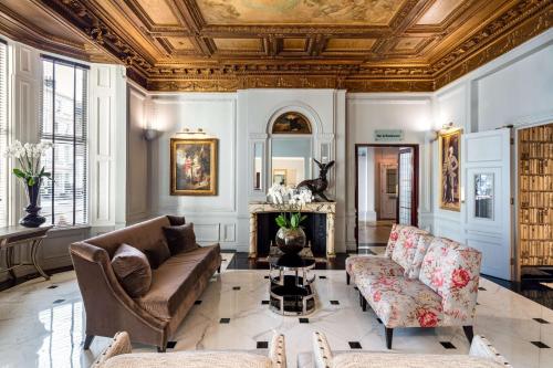 a living room with a coffered ceiling and a fireplace at Radisson Blu Hotel, London South Kensington - formerly Vanderbilt in London