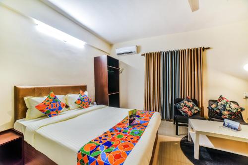 a bedroom with a bed and a desk and a chair at FabHotel K7 Trends With Pool, Baga Beach - Nr Baga Beach in Calangute