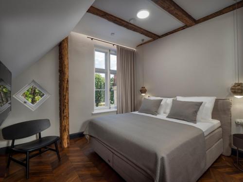 Rúm í herbergi á Boutique Hotel Rosenplänter