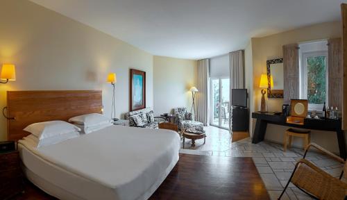 A bed or beds in a room at The Marmara Bodrum - Adult Only