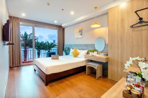 A bed or beds in a room at Happy Day Riverside Hotel & Spa Danang by Haviland