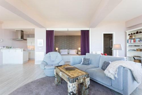 sala de estar con sofá azul y mesa en Prime Homes Playa Jardín Studio en Puerto de la Cruz