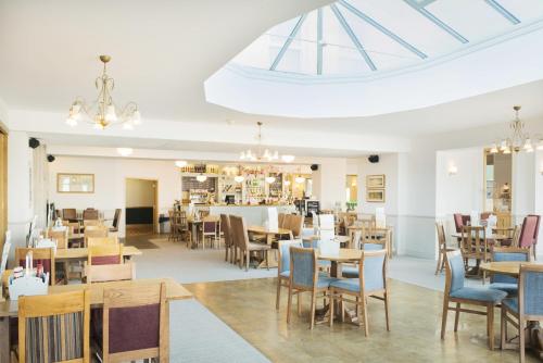 a dining room with tables and chairs and a skylight at Great Western in Newquay