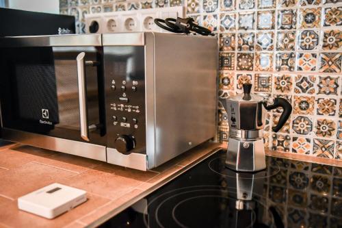 a microwave oven sitting on top of a kitchen counter at Bodrog33 Riverhouse in Tokaj