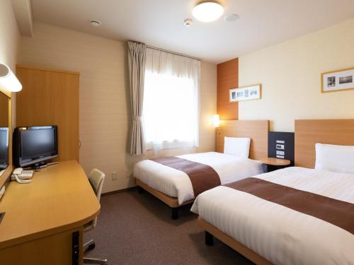 Ліжко або ліжка в номері Comfort Hotel Tomakomai