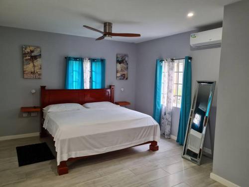 a bedroom with a bed and a mirror in it at Coconut Creek Deluxe Suite in Hyde Park