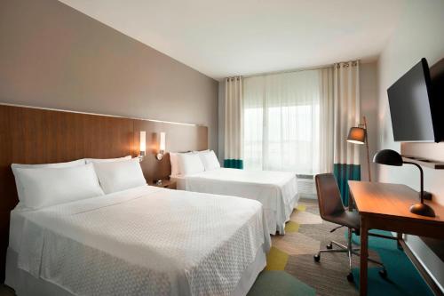 Tempat tidur dalam kamar di Four Points by Sheraton Miami Airport