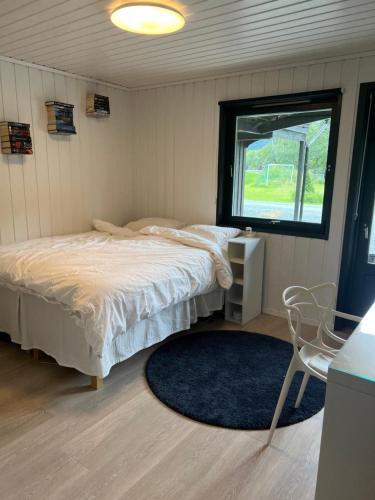 A bed or beds in a room at Lykkja - Beautiful Waterfront House