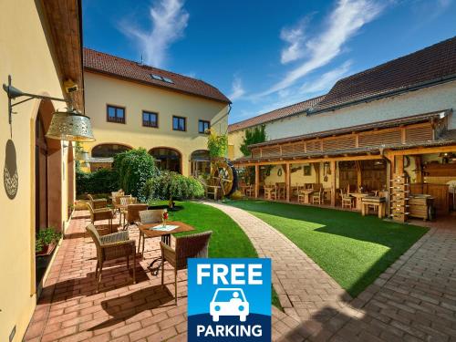 a building with a free parking sign next to a patio at Hotel Selsky Dvur - Bohemian Village Courtyard in Prague