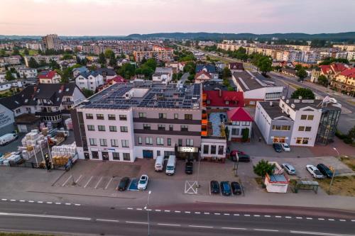 an aerial view of a city with cars parked in a parking lot at Hotel 107 in Rumia