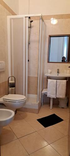 een badkamer met een douche, een toilet en een wastafel bij Hotel Bonazzi in Perugia