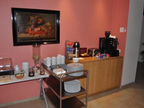 a kitchen with a counter with plates on a table at Hôtel - Ferme du Château d'Ahin in Huy