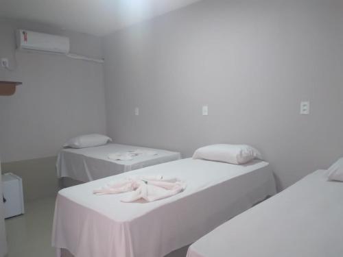 two beds in a hospital room with towels on them at HOTEL CAPITAL PALMAS in Palmas