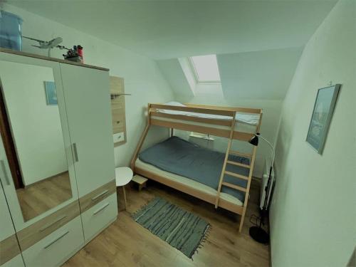 a small room with a bunk bed and a cabinet at Apartma Butterfly in Škofja Loka