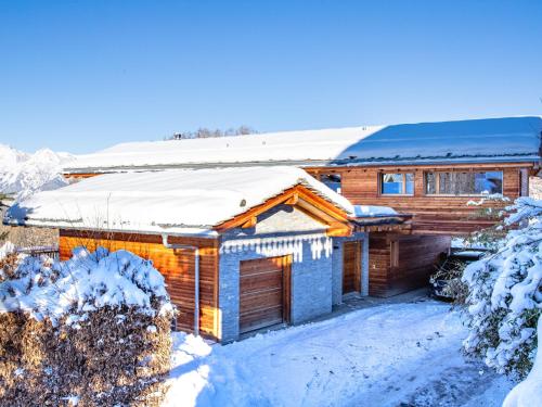 a log cabin with snow on the roof at Chalet Woovim 14-3 by Interhome in Nendaz