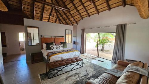 A bed or beds in a room at Makhato Bush Lodge 48