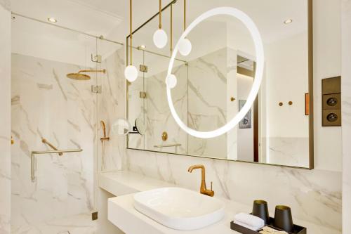 a bathroom with a sink and a mirror at Hotel Verte, Warsaw, Autograph Collection in Warsaw