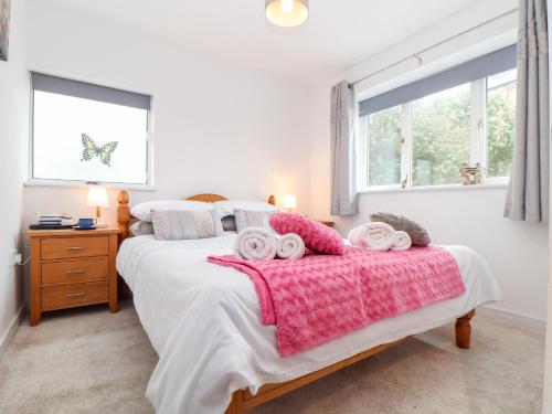 a bedroom with a bed with two towels on it at Sandyfeet in Camborne