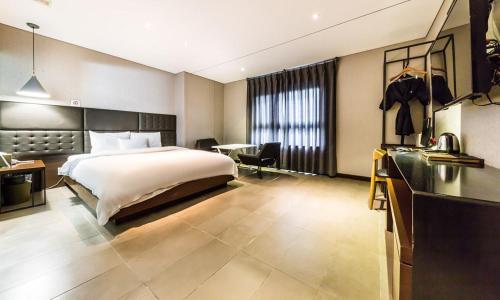 Habitación grande con cama y escritorio. en Yeongdeungpo Lifestyle F Hotel en Seúl