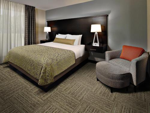 Habitación de hotel con cama y silla en Staybridge Suites Austin North - Parmer Lane, an IHG Hotel, en Austin