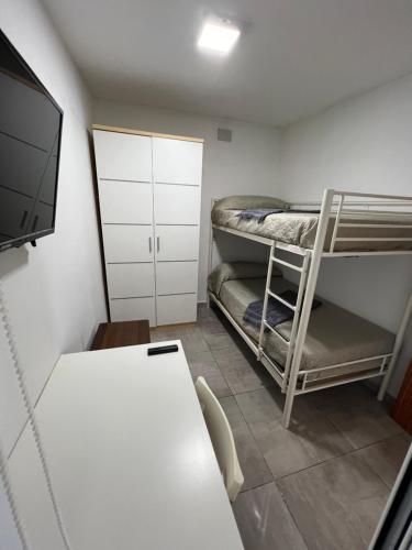 a room with two bunk beds and a table at Casa Paula in Ceuta