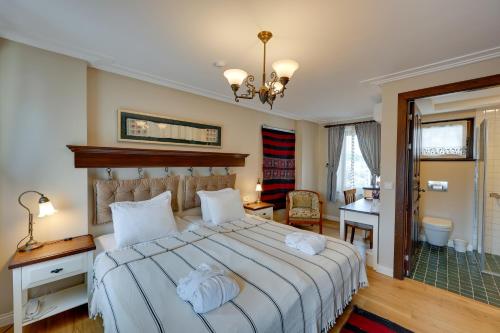 1 dormitorio con 1 cama grande y escritorio en Akanthus Hotel Ephesus en Selcuk