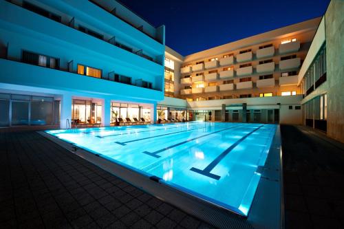 - une grande piscine dans un bâtiment la nuit dans l'établissement VEĽKÁ FATRA kúpele Turčianske Teplice, à Turčianske Teplice