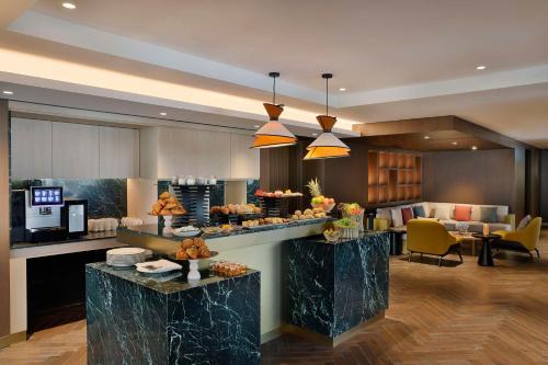 a lobby with a kitchen and a living room at Conrad Bahrain Financial Harbour in Manama