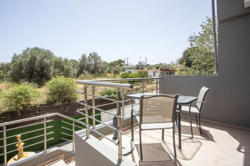 a balcony with a table and chairs and a view at Casa Sym Faliraki in Faliraki