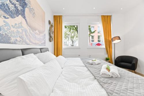 - une chambre avec un lit et des serviettes dans l'établissement Lemon3 - privater Garten mit Grill, Mini-Gym, zentral in Karlsruhe, à Karlsruhe