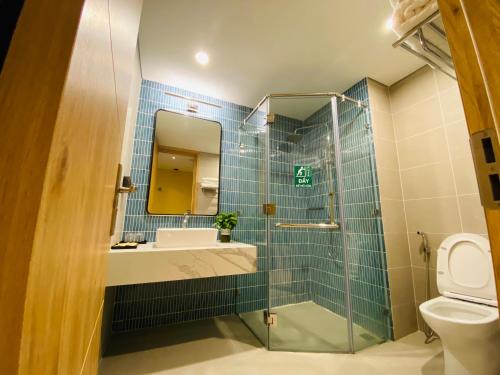 y baño con lavabo, espejo y aseo. en P1011 View Biển, Tầng 10 Hải Tiến en Thanh Hóa