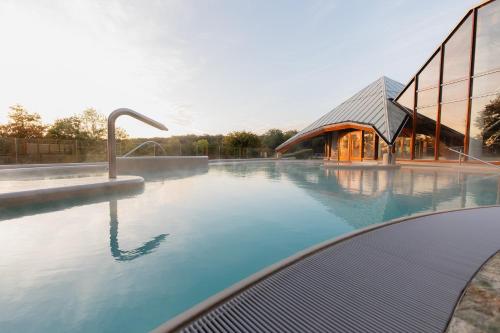 a swimming pool in front of a building at Thermae 2000 in Valkenburg