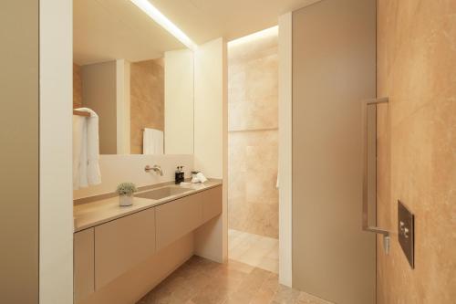 a bathroom with a sink and a mirror at Palmares Signature Apartments in Lagos