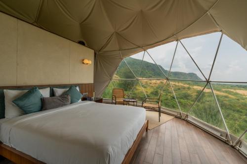 A bed or beds in a room at Teela- The Glamping Resort, Jaipur