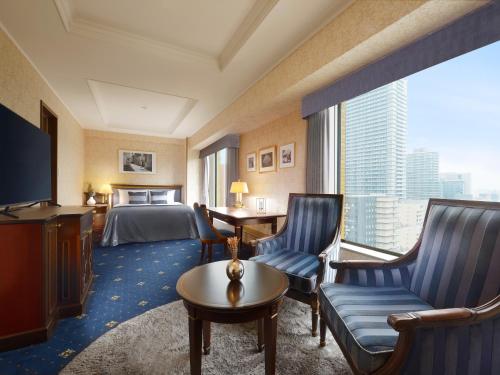 a hotel room with a bed and a large window at Nagoya Kanko Hotel in Nagoya