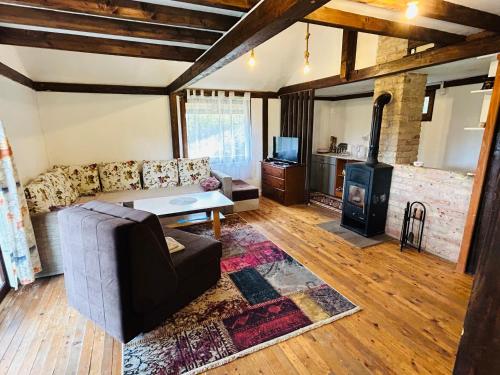 a living room with a couch and a wood stove at Log cabin 