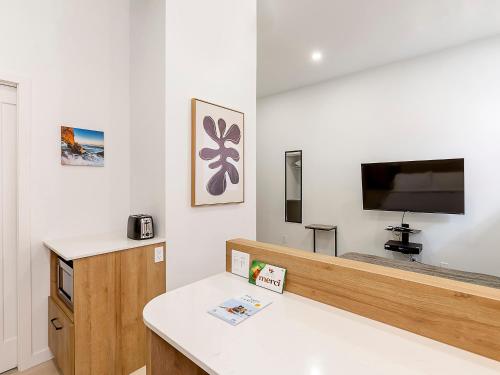 a living room with a bed and a flat screen tv at Lofts Orizon in Rimouski