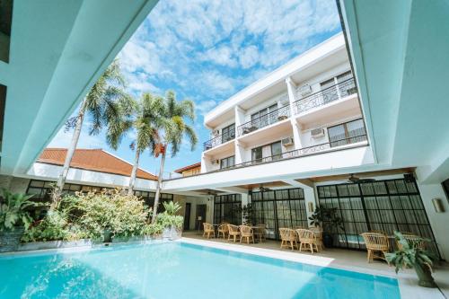 an indoor swimming pool in front of a building at Sugarland Hotel in Bacolod