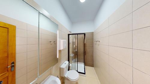 een badkamer met een toilet en een glazen douche bij Triana Rooms EH in Las Palmas de Gran Canaria