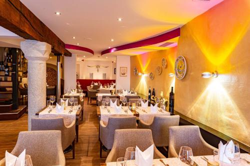 a dining room with white tables and chairs at Hotel Kronenhof in Schaffhausen