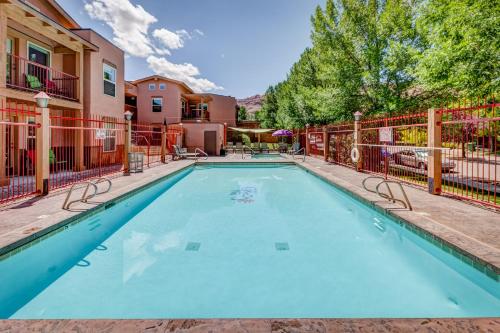 a swimming pool with a fence around it at The Gonzo Inn in Moab