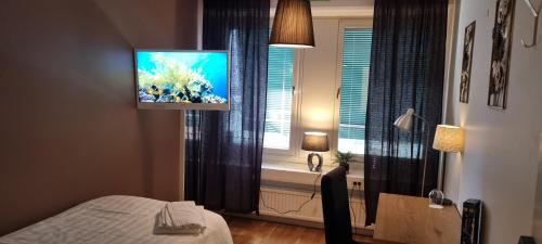 Habitación con cama y ventana con TV. en Hotell Västerås, en Västerås