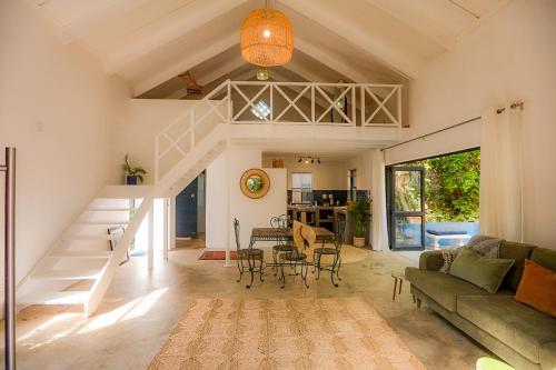 a living room with a staircase and a couch at Bamboo Cottage in Riebeek-Kasteel