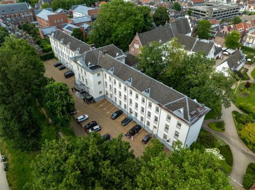 an aerial view of a building with cars parked in a parking lot at Grand Hotel Karel V in Utrecht