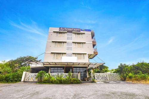 un edificio con un cartel en el costado en FabHotel Avasa Grand - Nr Big Daddy Casino en Old Goa