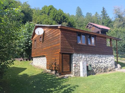 a small wooden house on a stone building at Chata Pohoda pri Jánošíku in Terchová