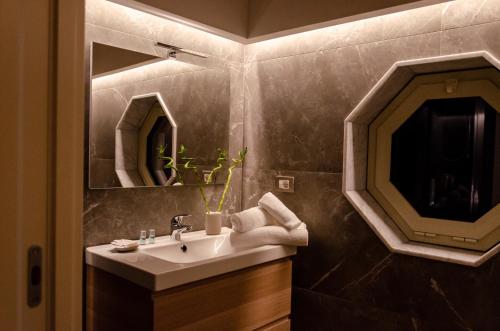 a bathroom with a sink and a mirror at Palazzo Fiammingo Rooms in Belpasso