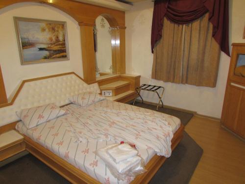 a bedroom with a bed and a mirror and a window at Pleasant Place Hotel in Sao Paulo