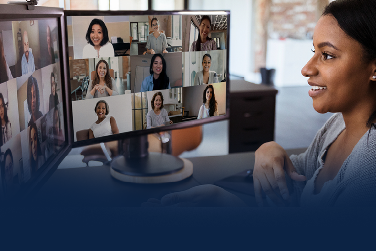 A woman smiling with a Microsoft video meeting on her computer screen